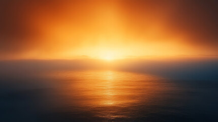 Fototapeta premium A beautiful sunset over the ocean with a foggy sky. The sky is orange and the water is calm
