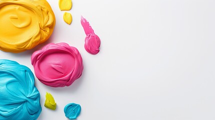 Three different colored frosting are spread out on a white background. The frosting is in the shape of a circle and is spread out in a way that it looks like a painting