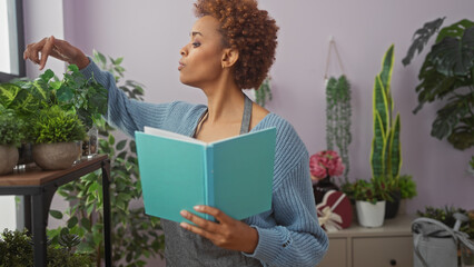 African american woman reading a book in a cozy flower shop surrounded by lush green plants