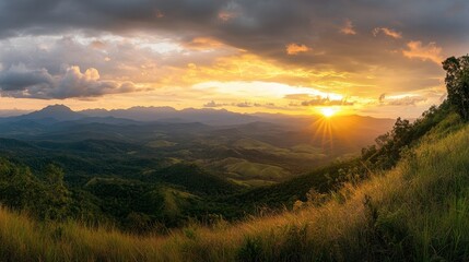 Fototapeta premium A sunset view over the mountains in Khao Yai National Park, with golden light illuminating the landscape.