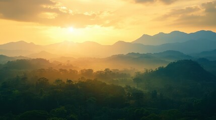 Obraz premium A sunset view over the mountains in Khao Yai National Park, with golden light illuminating the landscape.