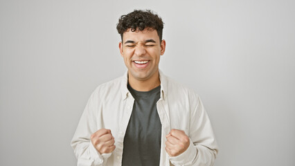 Happy man celebrating success with clenched fists against a white isolated background.