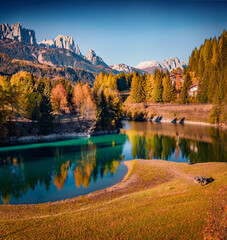Colorful autumn view of Soraga lake. Beautiful morning cityscape of Soraga di Fassa village,...