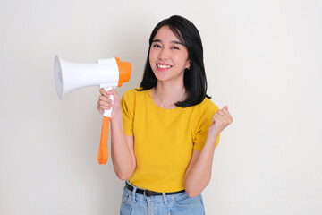 A woman showing happy expression while holding megaphone