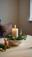 Cozy Christmas scene with candle, pine sprigs, and holiday decorations.