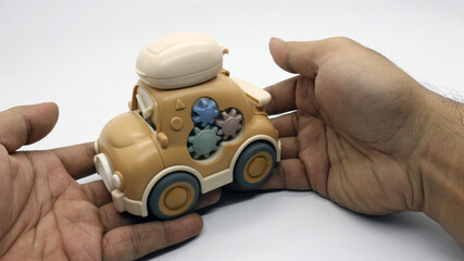Fototapeta premium A brown children's toy car that looks very cute