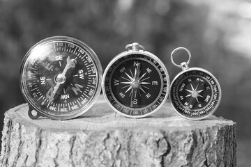 Classic navigation compasses on natural background