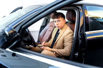 Portrait of a young businessman in a suit. International business trip.