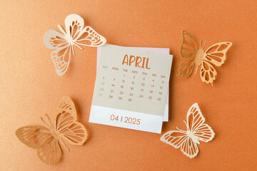 April 2025 calendar card with butterfly paper on orange.