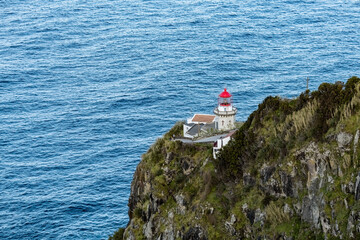 Lighthouse on the cliff at Terseira island Azores Portugal