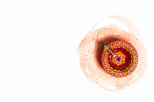 Diwali Diya over brush strokes on white background. Hindu festival of lights.