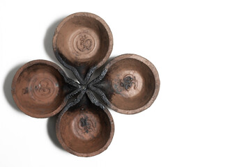 Traditional clay oil lamps are arranged in a flower pattern. Suitable for festive and religious celebrations.