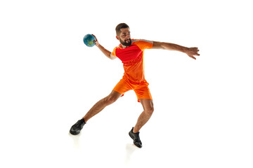 Scoring winning goals. Competitive young man, handball player in motion during intense game,...