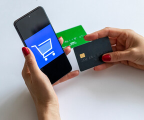 Shot of the woman holding credit card and the phone. Technology