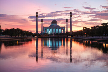 A large white Mosque with The water is calm and reflects the twilight sky, Central Mosque Songkhla, Thailand