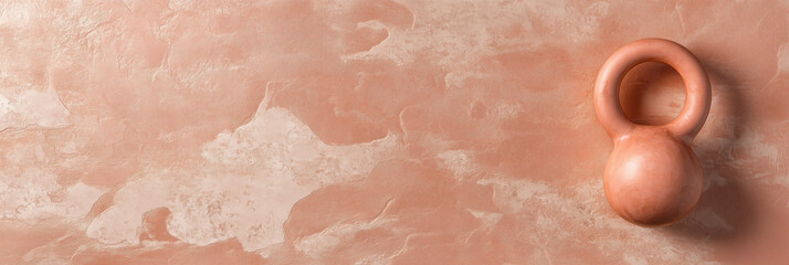 Fototapeta premium copper kettlebell rests on smooth, textured copper background, creating serene atmosphere