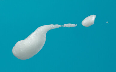 White bubble foam fly in many shape form and splashing in air. Bubble foam use to clean wash toilet kitchen bathroom. Blue background isolated