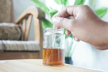 a man's hand is stirring tea