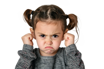 An angry little girl with clenched fists and furrowed brows, expressing her emotions.