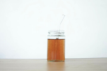 A glass of tea is placed on the table isolated on a white background