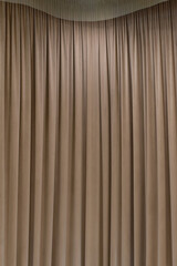 Dark brown curtain that dropped down as a straight line. Background for inserting text, empty spaces