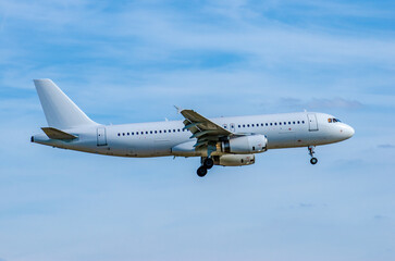 A white commercial airplane is arriving at the airport.