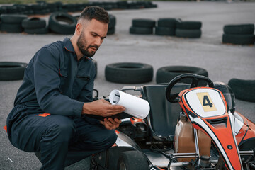 Man is outdoors, kart racing conception
