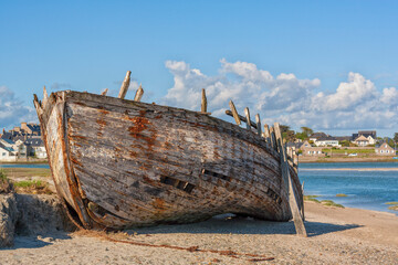 Wrecked wooden fishing boat at L'Olonde river bank, Portbail, Normandy, France