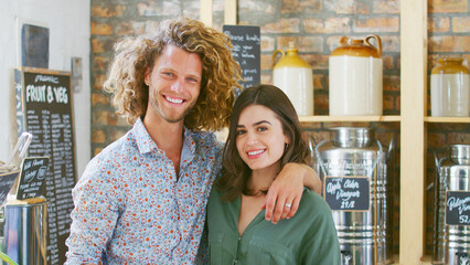 Portrait Of Smiling Young Couple Shopping In Sustainable Plastic Free Grocery Store