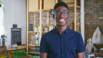 Fototapeta premium Portrait Of Smiling Young Man Shopping In Sustainable Plastic Free Grocery Store
