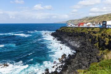 Naklejka premium Bright houses on the cliff at Atlantic ocean coast in Azores islands Portugal
