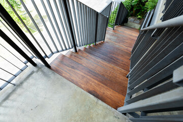 Steel and wood stairs are on the side of the building walls.