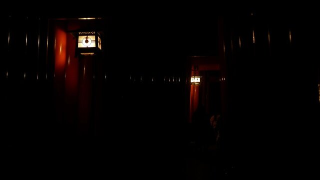night view of many torii japnese wooden gate along the walking way in Fushimi inari shrine in Kyoto without any people,famous tourist location of Kyoto