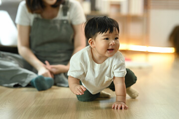 Adorable baby boy crawling on the floor, explore their surroundings Child development and nurturing care concept