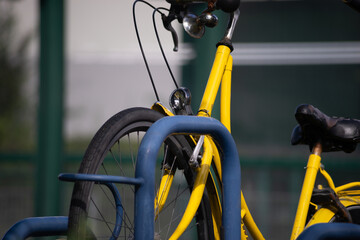 yellow bicycle at public bike rack