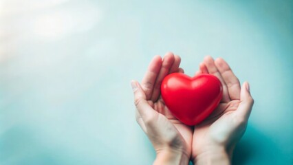 Fototapeta premium Protective Hands Holding a Red Heart 