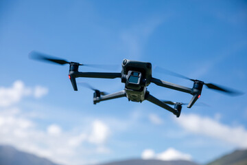 Drone flying under blue sky