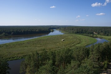 Wonderful landscapes in Lithuania from Merkine observation tower. Nemunas river and forest. Pastraujo isle. Sunny summer day. Selective focus