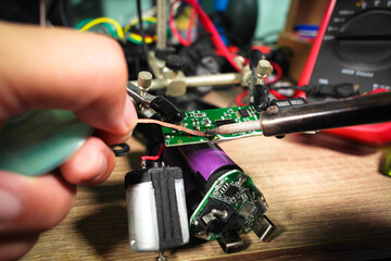 The extraction of lead using desoldering wire or solder wick and soldering iron by an electrician...