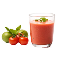 a glass of tomato juice next to tomatoes