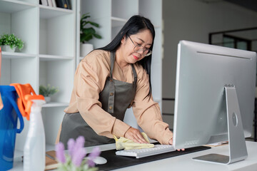 Housekeeper Skillfully Cleaning Office Desk and Accessories