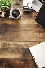 An overhead flat lay shot of a modern workspace setup on a rustic wooden desk.