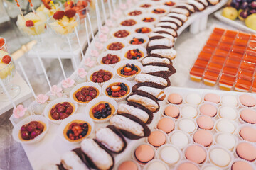 Wedding candy bar and different cap cakes. Candy bar. Table with sweets, candies, dessert. cookies and sweets with gorgeous arrangement