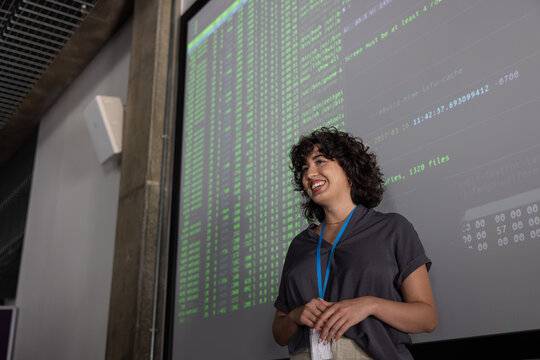 Young female coder presenting at a tech conference