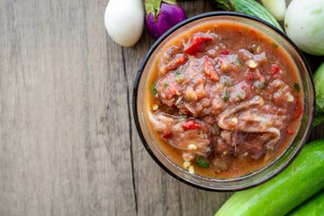 Thai spicy shrimp paste dipping sauce ( Nam prik kapi )and vegetable set on wooden  background with free copy space