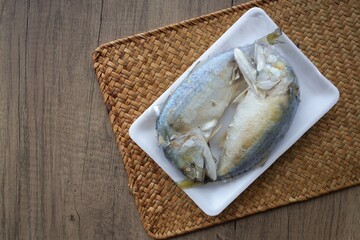  Mackerel  wrapped in plastic for sale  on wooden background, Thai called Plathu