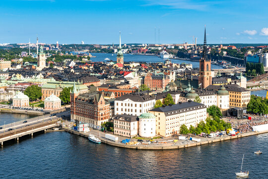 Aerial view of Stockholm cityscape with historical architecture, water, and landmarks on a sunny day.