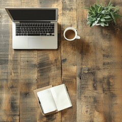 An overhead flat lay shot of a modern workspace setup on a rustic wooden desk.