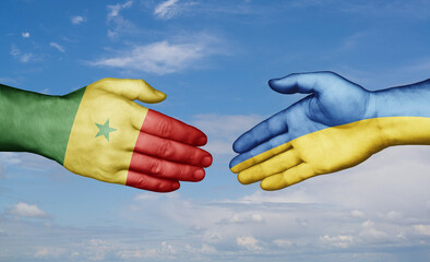 Ukraine and Senegal country handshaking with flags, consensus concept international co-operation illustration