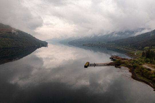 View of a loch with reflections in Glencoe, Scotland on a cloudy day.